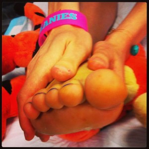 Tigger offering support holding up injured foot and loving hands holding foot before surgery